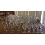 A suite of drinking glasses with etched leaf and flower detail including large wine glasses,