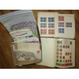 A box containing a stamp album with British and worldwide stamps, a quantity of unsorted loose