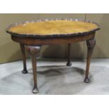 An oval walnut occasional table on shell carved knees, small carved oak stool and an Edwardian