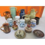A large collection of unmarked studio pottery to include jugs, tankards, vases, a lamp, etc (14)