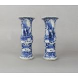 A pair of 19th century oriental blue and white vases of cylindrical form with knopped centres and
