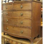 A Regency mahogany bow fronted bedroom chest of two short over three long graduated drawers raised