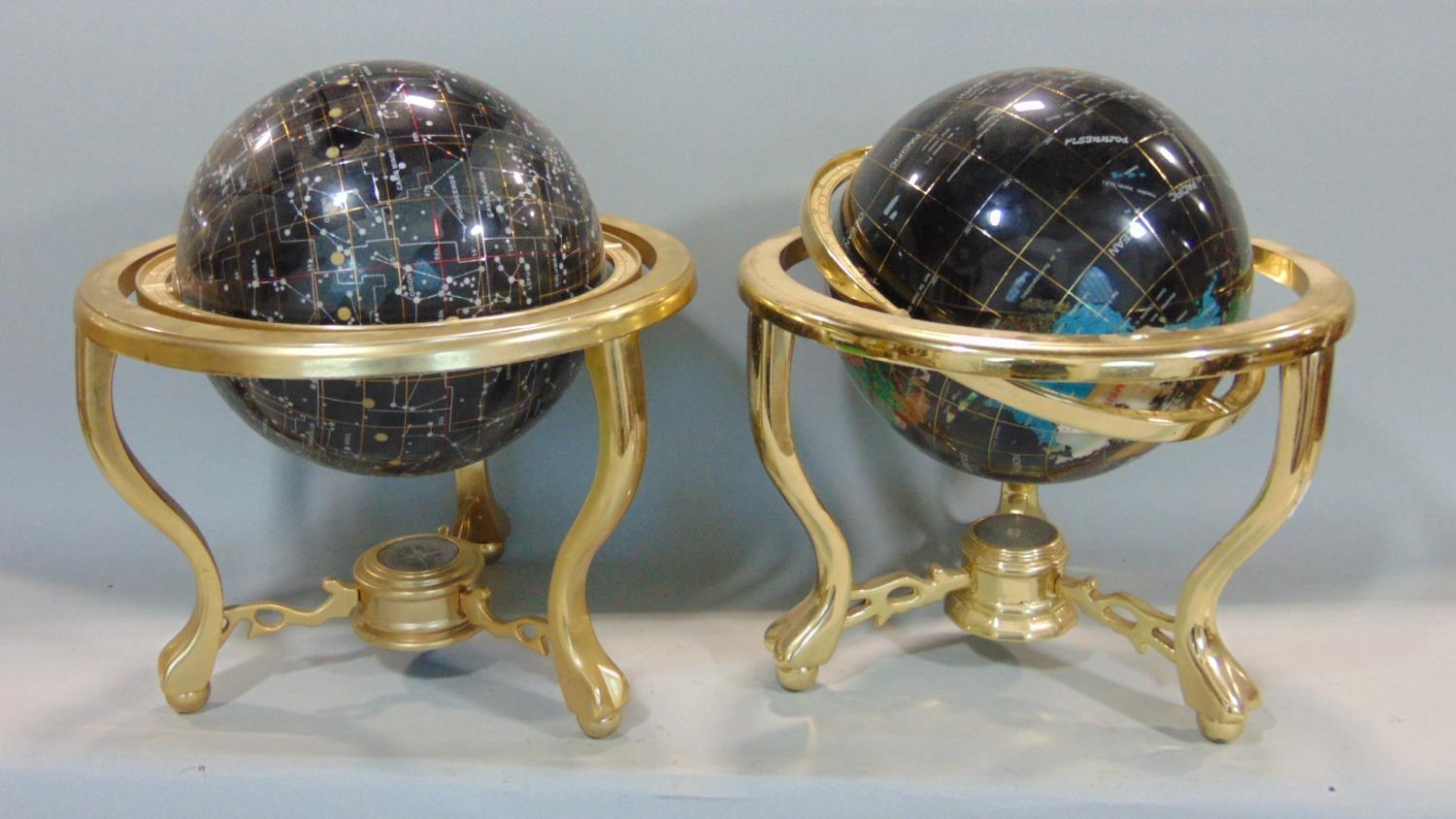 A pair of contemporary celestial and terrestrial globes, raised on brass frameworks, 30cm diameter