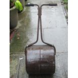 A small vintage cast iron garden roller
