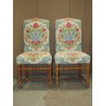 A pair of side chairs, raised on bobbin supports and rails, with upholstered seats and back together