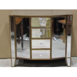 A contemporary shallow breakfront side cabinet with segmented bevelled edge mirror panels enclosed