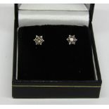 Pair of 9ct white gold diamond stud earrings, 1.2g