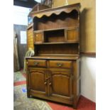 A good quality reproduction Georgian style oak cottage dresser with distressed finish, the base