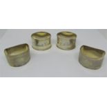 Four silver napkin rings, with engraved or engine turned detail, 3oz approx, together with a cased