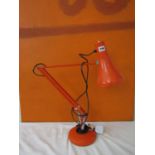 Herbert Terry & Sons Ltd anglepoise lamp in orange, with circular weighted base, 60cm high approx