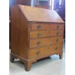 A simple Georgian mahogany country made bureau in oak with four long graduated drawers, fall flap