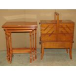 A graduated nest of three Georgian style occasional tables with figured walnut inlay, raised on