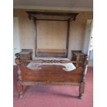 A Victorian walnut half tester bedstead, the footboard with turned rail and supports (af)