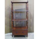 A 19th century mahogany four tier whatnot enclosing a lower frieze drawer with simple turned