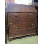 A Georgian oak bureau, the fall flap enclosing a fitted interior of small drawers, pigeon holes