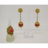 Eastern yellow metal filigree coral coloured ring and a pair of earrings, unmarked, test as 18ct