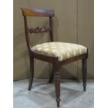 A set of four 19th century rosewood bar back dining chairs with carved and scrolled splats, over