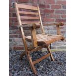 A set of four good quality contemporary teak folding garden armchairs with slatted seats and backs