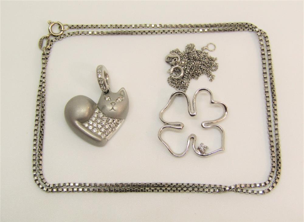 Group of white gold jewellery comprising a heart shaped pendant in the form of a cat, a four leaf