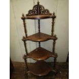A Victorian walnut and figured walnut four tier graduated corner whatnot, with tapering barley twist