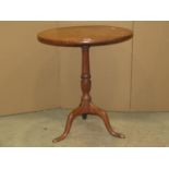 A Georgian mahogany snap top table, the circular one piece top, raised on a vase shaped pillar and
