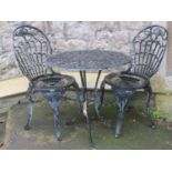 A cast aluminium three piece garden terrace set with decorative pierced scrolling foliate detail