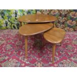 Ercol - Nest of three light elm 'Pebble' tables, the largest 64cm wide x 40cm high (3)