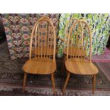 Set of four Ercol light elm high back Windsor chairs in elm, to include one caver (4)