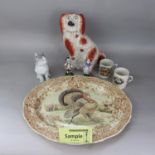 A 19th century Staffordshire spaniel, a Poole Pottery white glazed model of a cat, a continental