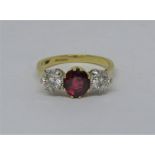 18ct three stone ruby and diamond ring, diamonds 0.30cts each approx, size N/O, 4.2g