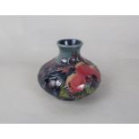 A Moorcroft vase in the Finch and Fruit pattern, of squat form, with impressed marks to base and