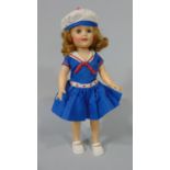 A 1950's Shirley Temple doll in sailor dress with closing eyes, height 36cm, together with 3 small