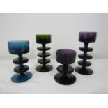 Four Wedgwood Kings Lynn Sheringham candle holders, a graduated pair of amethyst, a green and