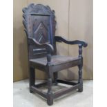 17th century oak wainscott chair, the panelled back with geometric and carved detail, simple dog