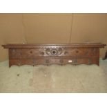 An oak wall hanging hall shelf and combined coat/hat rack with carved foliate and lozenge detail