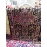 A Persian wool carpet with red field within foliated borders 200 x 135 cm approx, together with a
