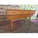 1950s beech side board, fittedwith three short drawers over a concealed deep drawer, upon splayed