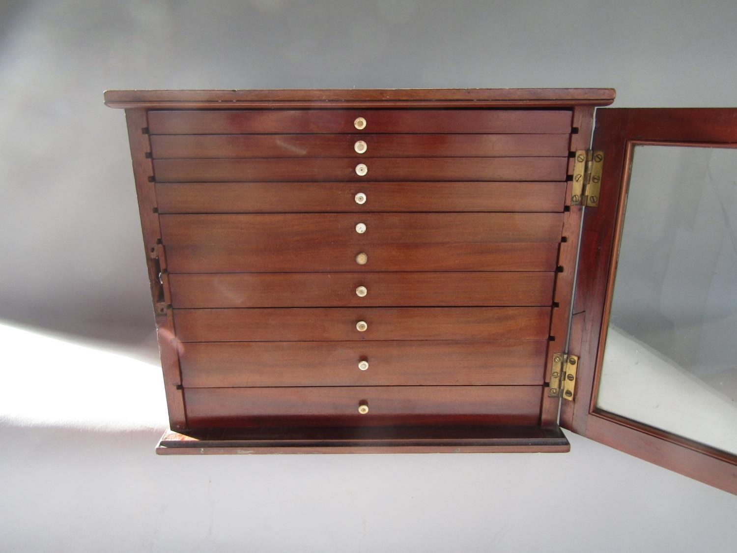A good quality Victorian mahogany specimen or collectors cabinet, the glass panelled front enclosing