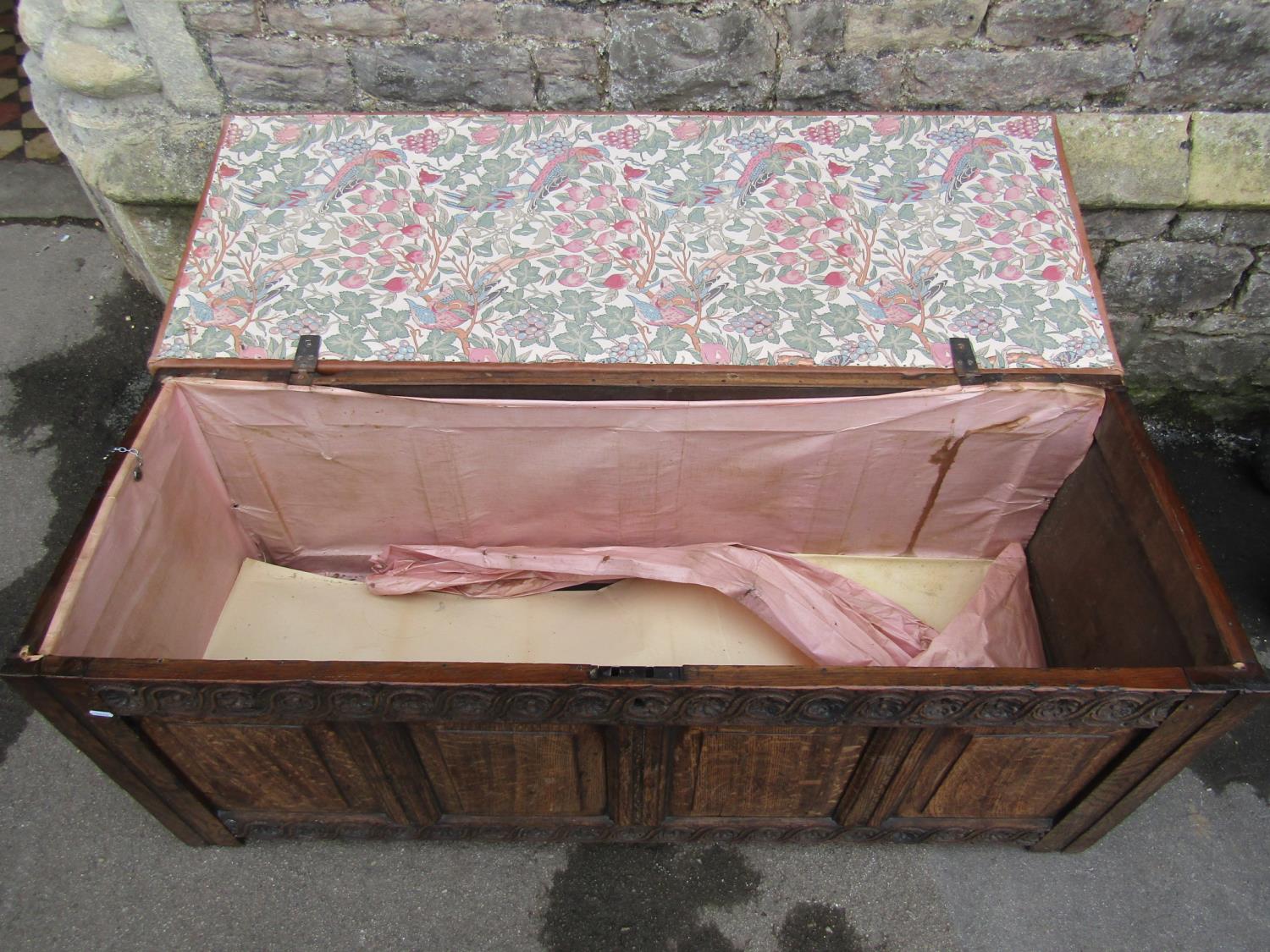 An 18th century oak coffer with panelled frame, moulded styles and carved foliate detail beneath a - Image 2 of 4