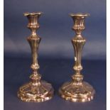 A pair of silver plated candlesticks of gadrooned form with knopped stems raised on circular