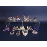 A collection of Swarovski crystal miniature wares including a swan, a cockerel and a hen, a peacock,