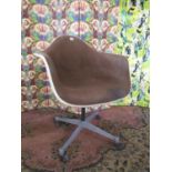 Charles Eames for Herman Miller fibre glass bucket swivel chair, with brown upholstery upon a four