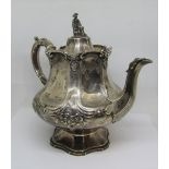 A substantial Victorian silver pagoda teapot of hexagonal form, with embossed floral detail,