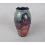 A Moorcroft vase in the Finch and Fruit pattern with impressed marks to base and faint initials WM