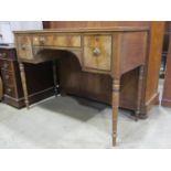 A Regency mahogany side table fitted with an arrangement of three frieze drawers with ebony