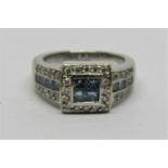 18ct white gold diamond ring, set with circular diamonds and fancy blue princess cut diamonds,