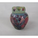 A Moorcroft Ginger Jar and cover in the Finch and Fruit pattern with impressed marks to base, 11cm