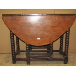 An 18th century gateleg table in mixed woods including yew-wood and fruitwood raised on turned