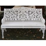 A Coalbrookdale style two seat garden bench, the cream painted cast alloy frame with decorative