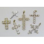 Six 14k cubic zirconia set cross pendants of varying design, 16.9g total (6)